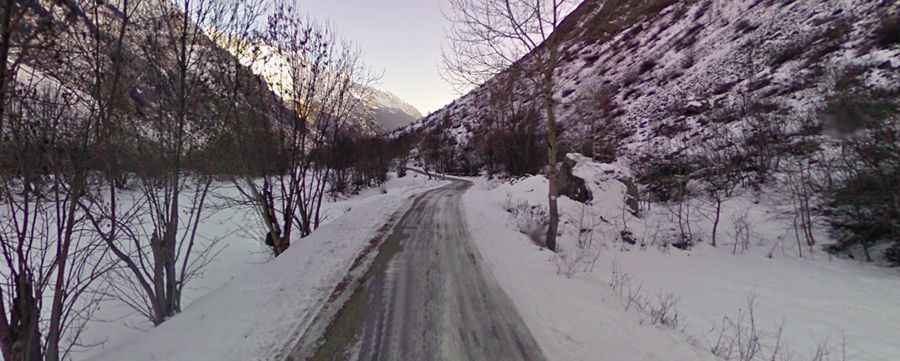 A paved road to Chalet Hotel du Gioberney in the heart of the Ecrins Park