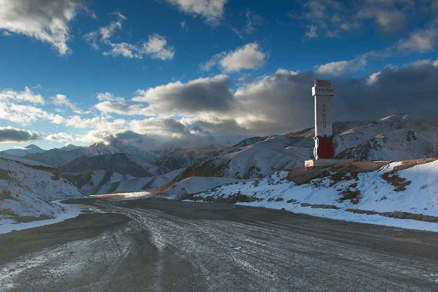 Is the road through Kara Koo Pass unpaved?